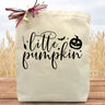 script little pumpkin printed in black on a canvas tote bag sitting on a table