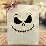 black printed face skeleton on a canvas tote bag sitting on a table