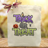 purple and green trick or treat printed on a canvas tote bag sitting on a table