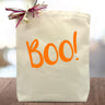 Orange Boo! printed on a canvas tote bag sitting on a table
