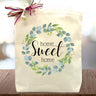 Floral home sweet home printed on a canvas tote bag sitting on a table
