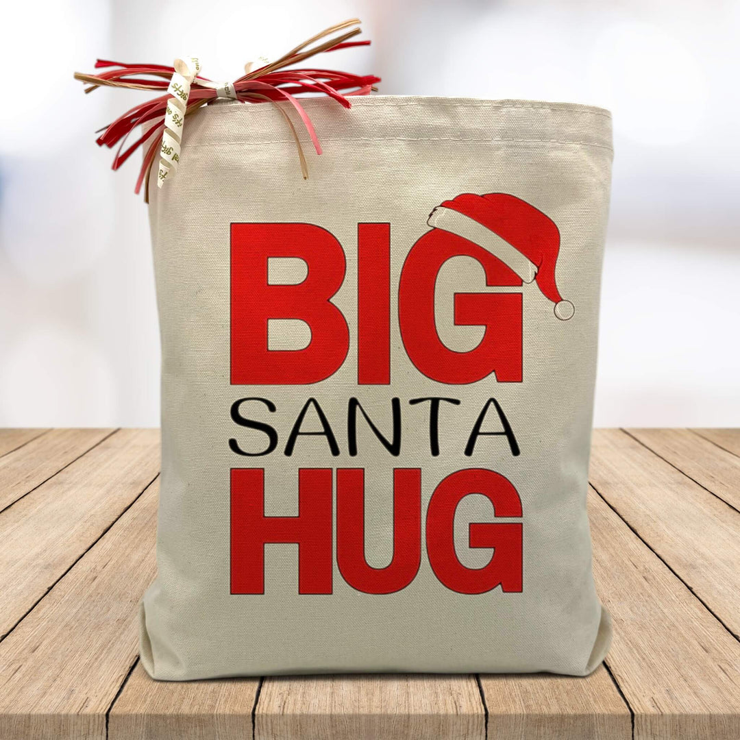 big santa hug printed on a canvas tote bag sitting on a wood table with a white blurred background