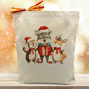 3 christmas themed critters printed on a canvas tote bag sitting on a wood table with a gold background