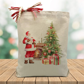 Santa with presents and a christmas tree printed on a canvas tote bag sitting on a wood table