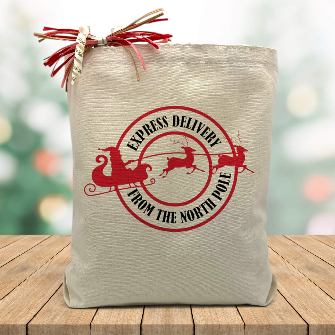 express delivery from the north pole  printed on a canvas tote sitting on a wood table