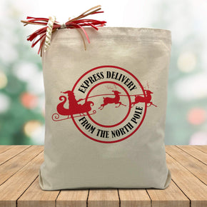 express delivery from the north pole  printed on a canvas tote sitting on a wood table
