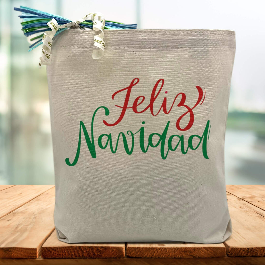 felix navidad in red and green printed on a canvas tote bag sitting on a wood table