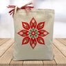 holiday folk flower printed on a canvas tote bag sitting on a wood table with a blurred whie background