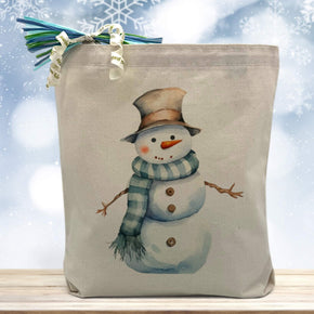 snowman printed on a canvas tote bag sitting on a table with a snowflake background