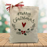 Merry christmas with a heart and wrath printed on a canvas tote bag sitting on a wood table