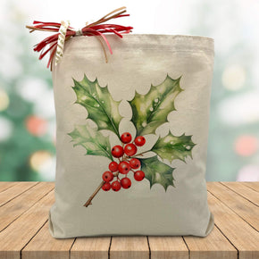 holly branch printed on a canvas tote bag sitting on a table with a blurred christmas tree background
