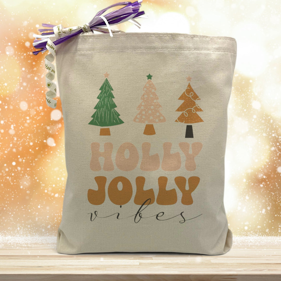 holly jolly christmas tree printed on a canvas tote bag sitting on a table with a gold background
