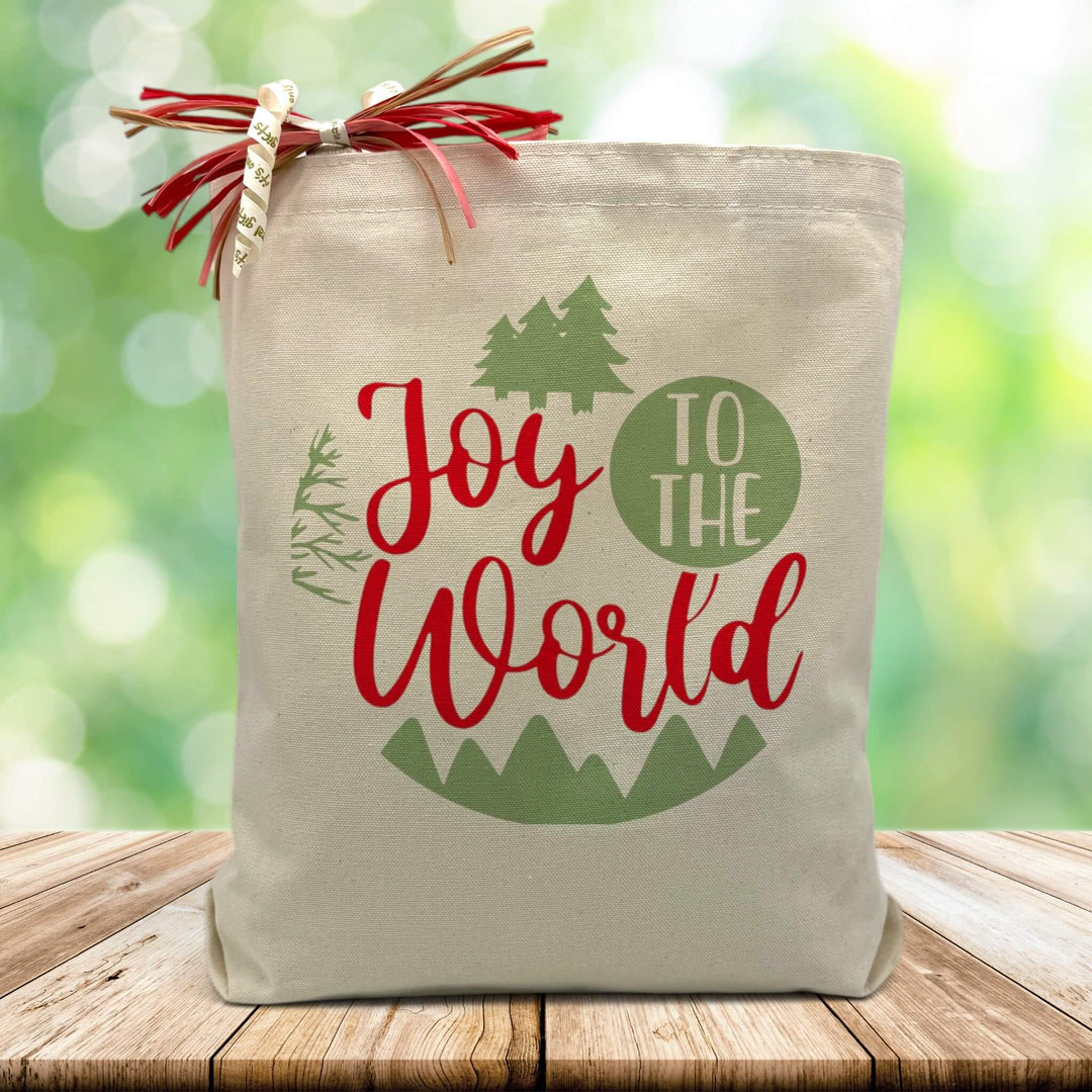 joy to the world printed on a canvas tote bag sitting on a wood table