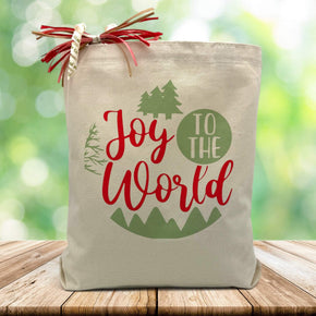 joy to the world printed on a canvas tote bag sitting on a wood table