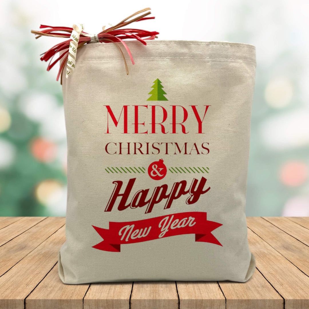 merry christmas and happy new year printed in red and green on a canvas tote bag sitting on a wood table