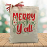 merry christmas yall in red and green printed on a canvas tote bag sitting on a wood table