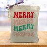 colorful merry merry merry christmas printed on a canvas tote bag sitting on a wood table