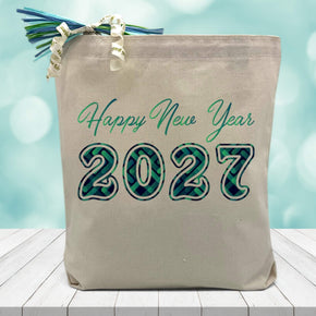 2027 happy new year in blue printed on a canvas tote bag sitting on a table