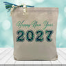 2027 happy new year in blue printed on a canvas tote bag sitting on a table