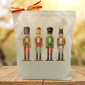 4 nutcrackers printed on a canvas tote bag sitting on a wood table