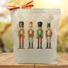 4 nutcrackers printed on a canvas tote bag sitting on a wood table