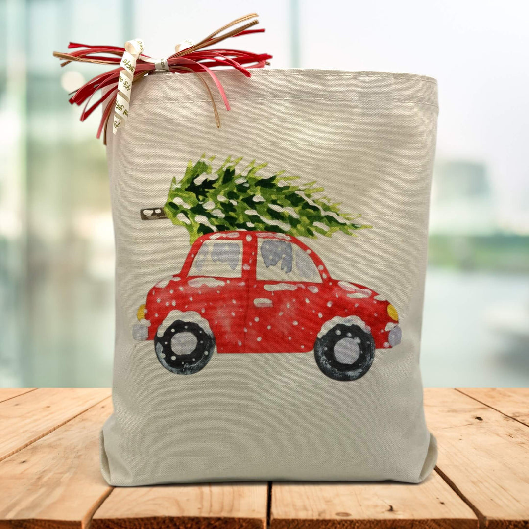 red car with a green christmas tree on top printed on a canvas tote bag sitting on a wood table