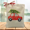 red car with a green christmas tree on top printed on a canvas tote bag sitting on a wood table