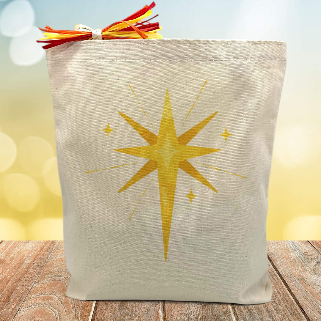 yellow start printed on a canvas tote bag sitting on a wood table