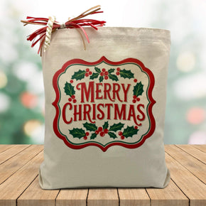 Merry christmas sign printed on a canvas tote bag sitting on a wood table with a holiday background