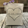heart with custom date printed inside on a canvas tote bag sitting on a rustic table
