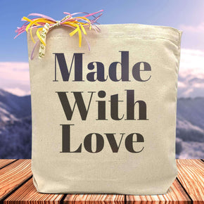 made with love printed in black print on a tote bag sitting on a table