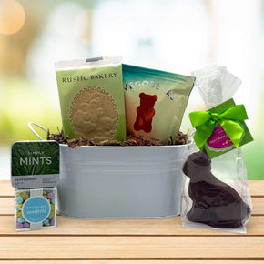 small white tin tub with minds, candies, gummy bears and cookie