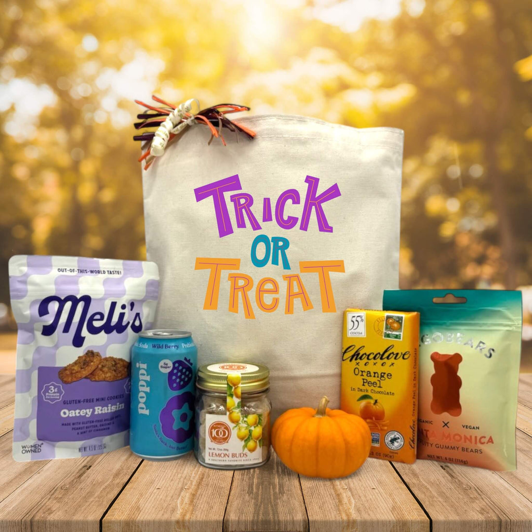 trick or treat gift basket with cookies, poppi, lemon buds, knit pumpkin, chocolate, and gummy bears