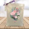 pink and blue flower bouquet printed on canvas tote bag sitting on table with white blurred background