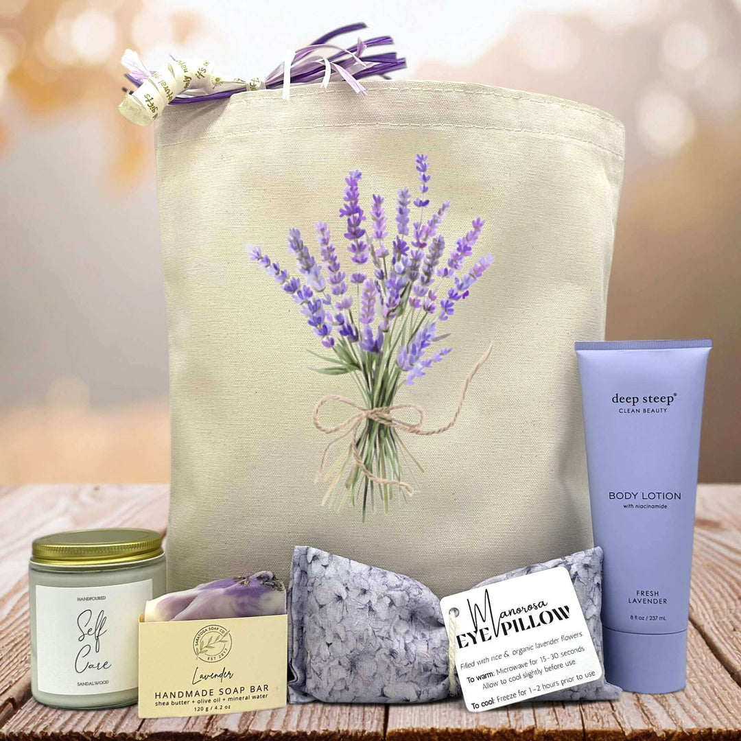 lavender bouquet printed on canvas tote with a candle, soap bar, eye pillow and lotion sitting on a table