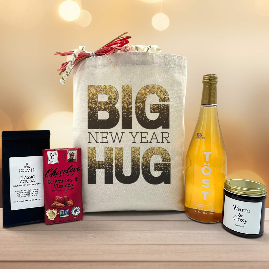 Gourmet new year gift basket with cocoa, chocolate, a large candle and sparkling juice
