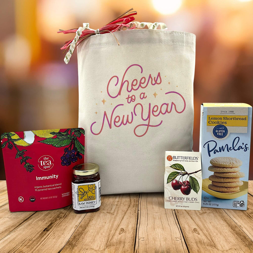Cheers to a new year canvas bag with tea, honey, cherry buds, and cookies