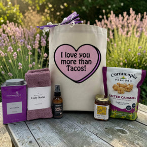 purple themed gift with cocoa, socks, calming spritz, honey jar and salted caramel popcorn