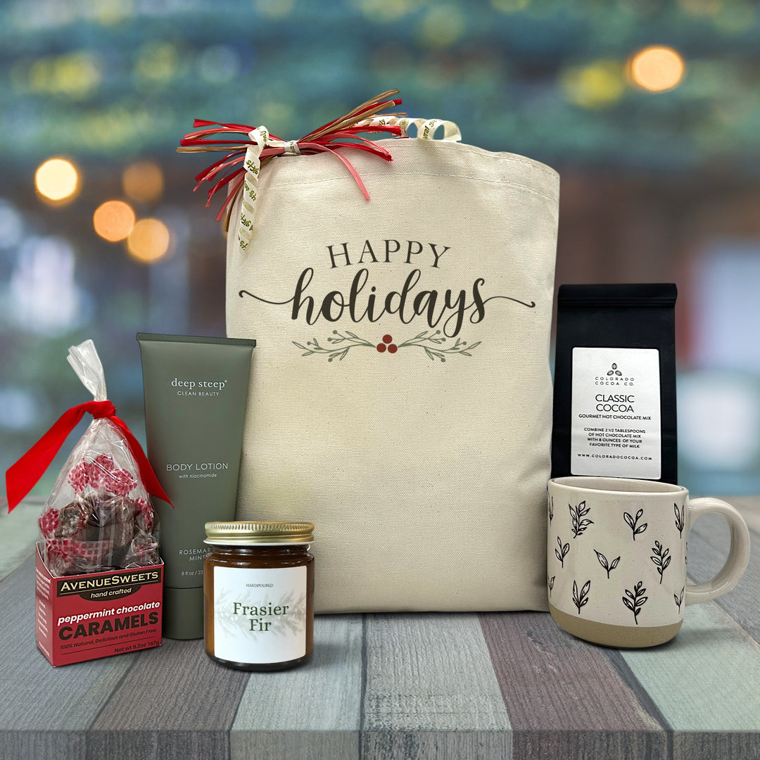 Gourmet holiday gift basket with peppermint caramels, rosemary lotion, candle, mug and cocoa