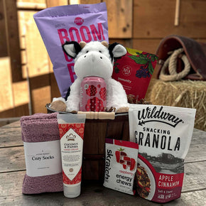 apple bushel with popcorn, tea, poppi, stuffed cow, socks, lotion, energy chews and granola