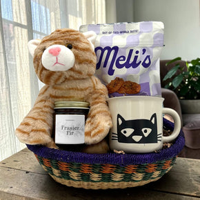Gourmet cat holiday gift basket with a stuffed cat, cookies, a candle and a cat mug