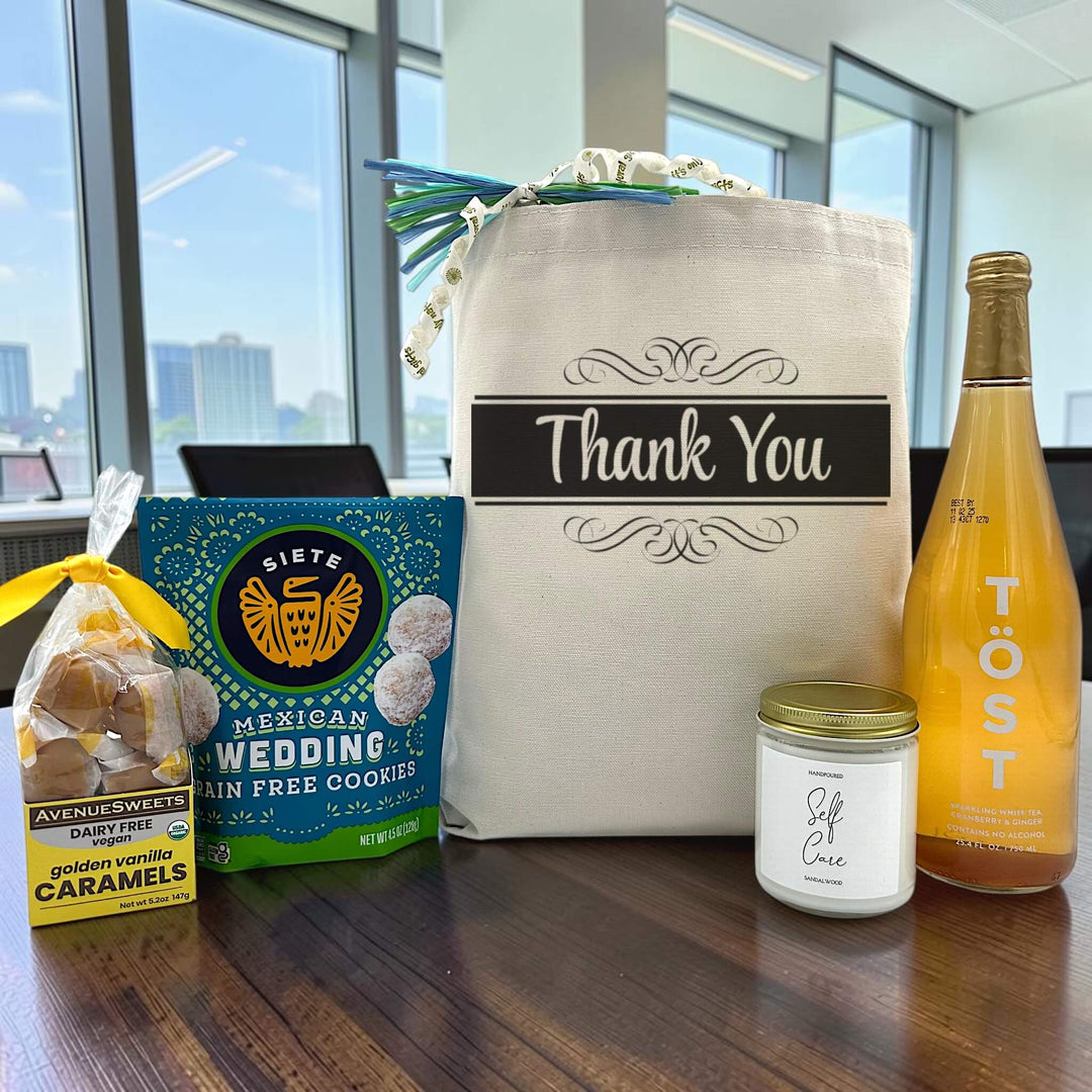 Gourmet thank you gift basket with caramels, cookies, a large candle and sparkling juice