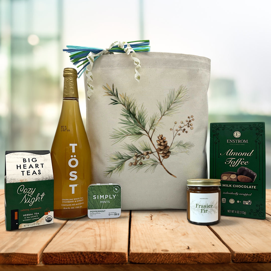 fasier fir printed gift basket with tea, sparking juice, mints, a candle and almond toffee