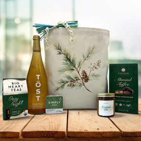 fasier fir printed gift basket with tea, sparking juice, mints, a candle and almond toffee