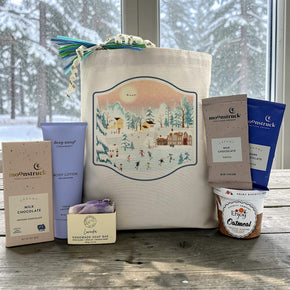 Gourmet winter gift basket with a chocolate bar, lotion, soap, cocoa packets and oatmeal