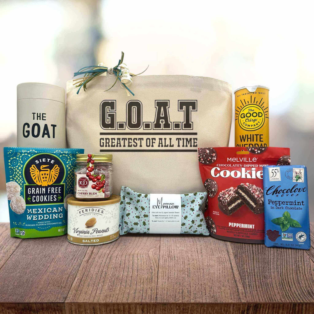 Gourmet holiday gift basket with a drinking glass, cookies, peanuts, cherry buds, an eye pillow, cookies, chips and chocolate