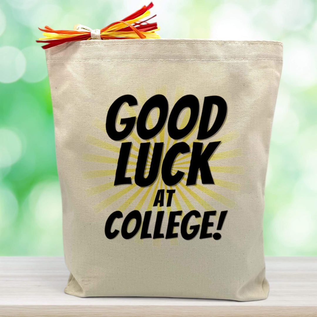 good luck at college with yellow lines printed on canvas tote bag sitting on table with green blurred background
