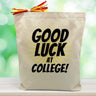 good luck at college with yellow lines printed on canvas tote bag sitting on table with green blurred background
