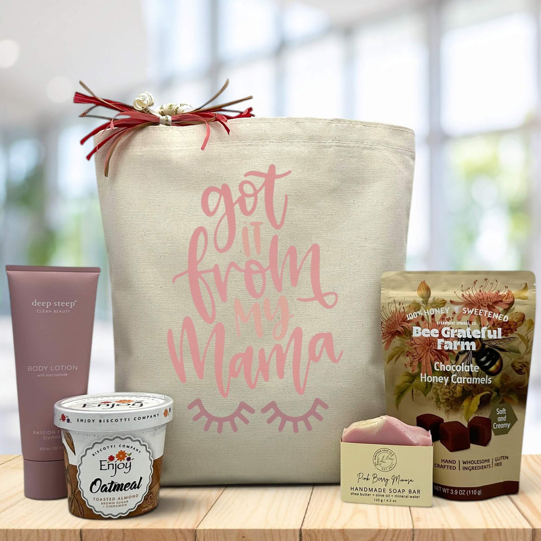 got it from my mama written on tote bag sitting on table with lotion, oatmeal, soap, and caramels