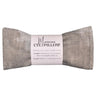 grey distressed fabric eye pillow filled with lavender and rice laying on white surface with manorosa branded tag